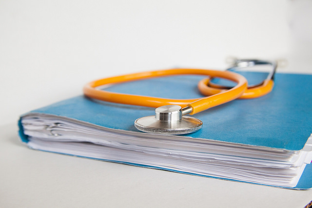 Image of doctor's stethoscope on top of patient's records - Search Influence