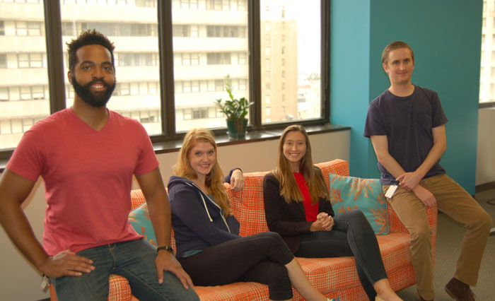 Employees at Search Influence sitting on a couch
