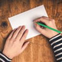 Image Of Girl Writing On A Blank Card At Her Desk - Search Influence