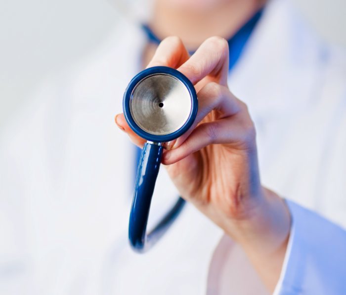 Doctor holding out stethoscope - Search Influence