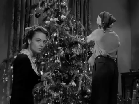 Tinsel being placed on a tree in It's a Wonderful Life - Search Influence