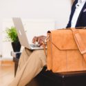 Man sitting down typing on his laptop