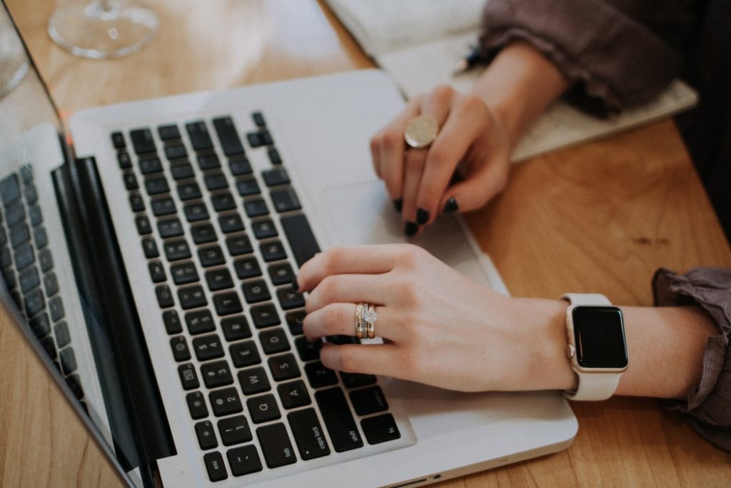 Woman's hands typing on her laptop