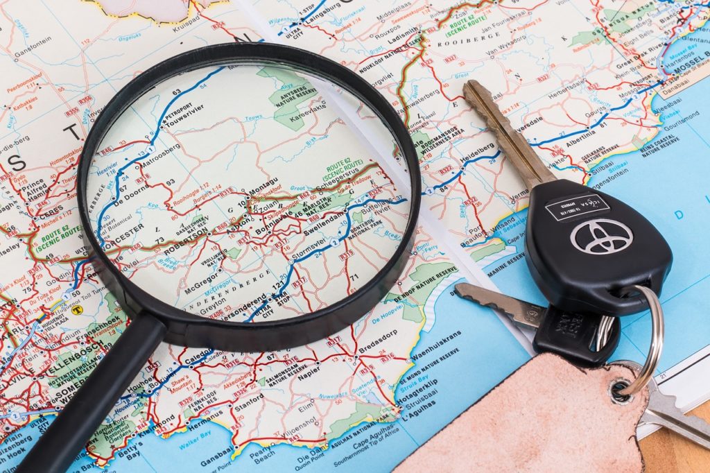 Magnifying glass and set of keys on top of map