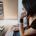 A woman sitting at a desk working on a computer