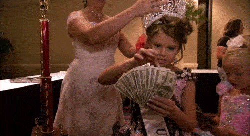 Little pageant girl counting lots of money