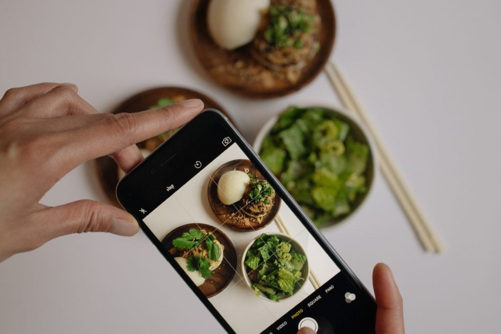 Restaurant owner taking photographer of their menu items for marketing use