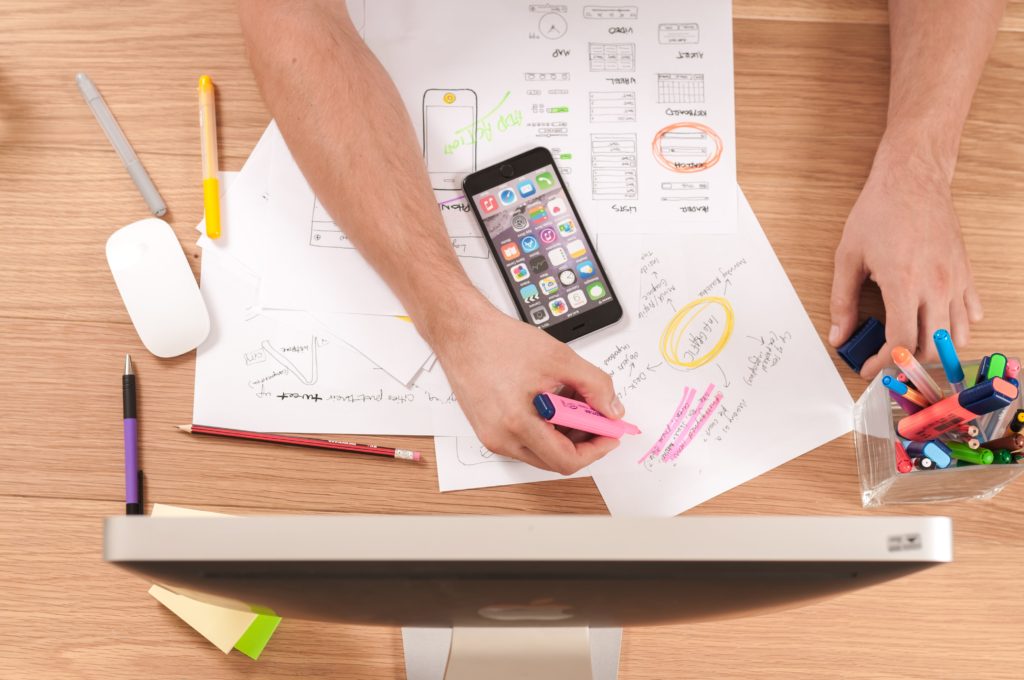 Person using highlighter on business documents on desk