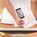 Person using highlighter on business documents on desk