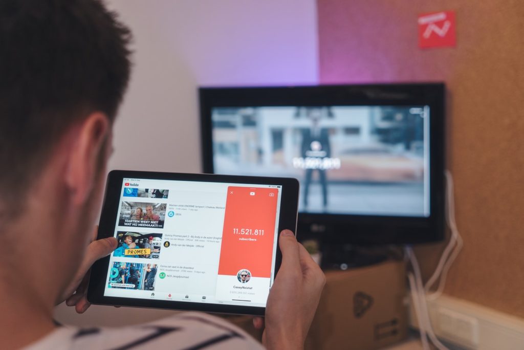 A person using Youtube's app on a tablet 