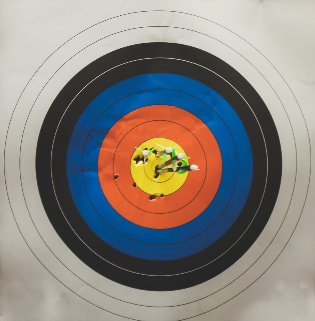 Target with arrows piercing the yellow center