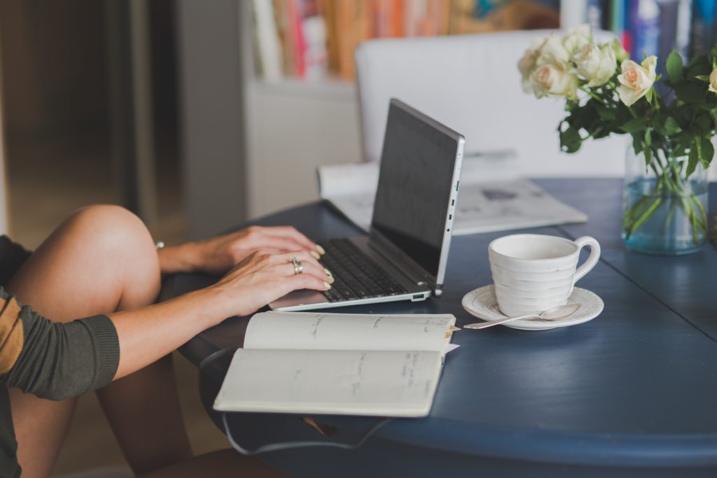 Graduate student sitting at a desk working on a laptop