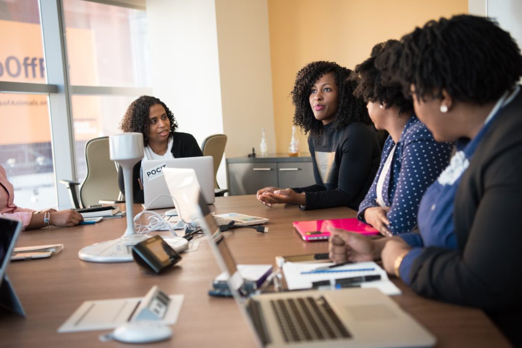 A group of women sitting at a conference table