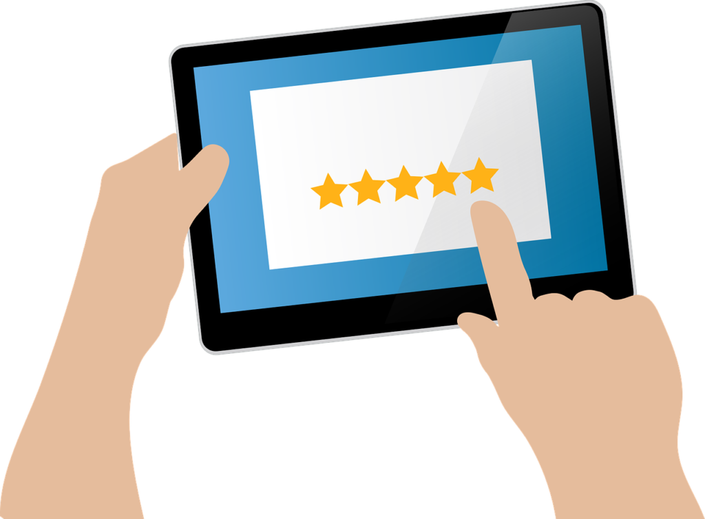 Graphic of a hand using a tablet to read online reviews of a business