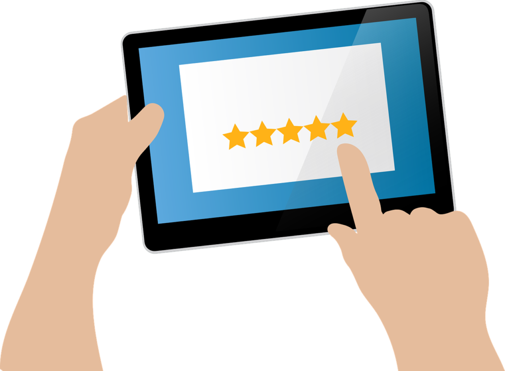 Graphic of a hand using a tablet to read online reviews of a business