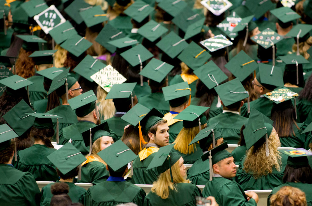 College graduation ceremony with graduates in caps and gowns