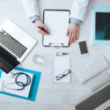 Doctor writing medical records at a desk