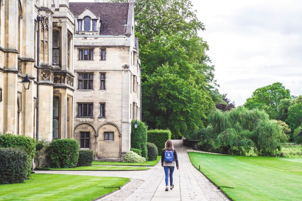 a student walking down a paved pathway