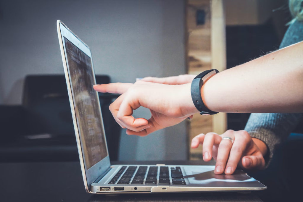 healthcare digital marketers pointing at laptop screen