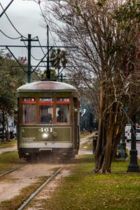 Streetcar riding down st charles avenue in new orleans, la