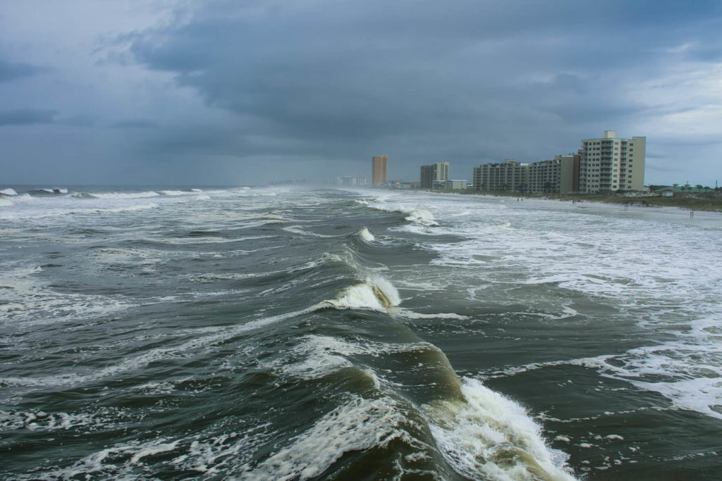 Waves crashing onto beach during a hurricane