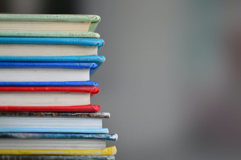 Photo of colorful books stacked on top of one another