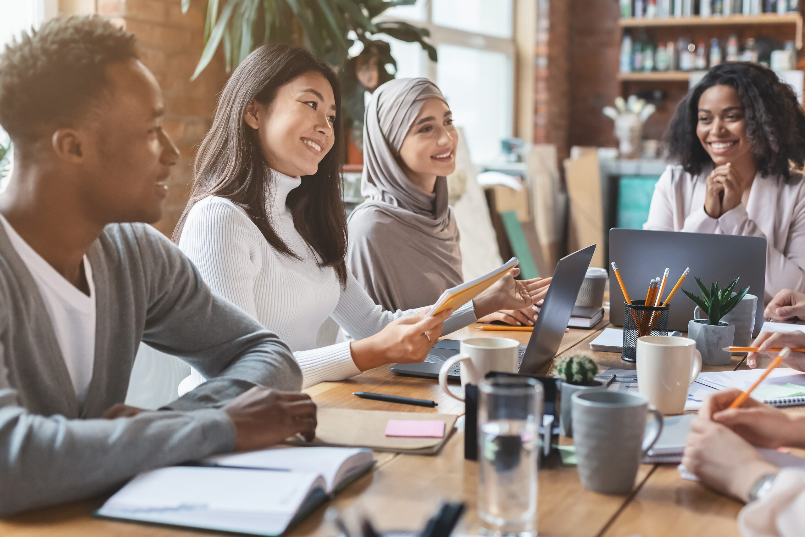 Image of a higher education marketing agency with four people working on a digital marketing strategy.