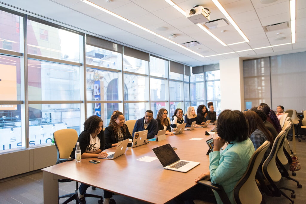 Business team members in a conference room discussing investing in SEO - Search Influence