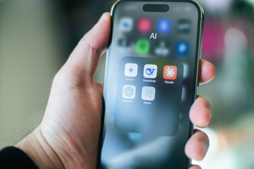 a-hand-holds-a-smartphone-with-various-apps